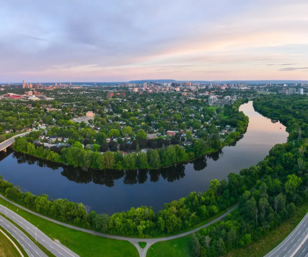 An aerial view of a city with a river in the background.