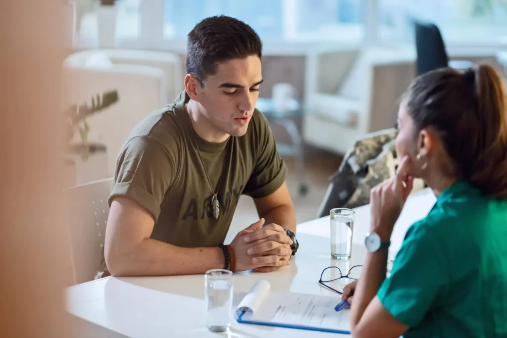 A veterans military man and a woman talking at a table.